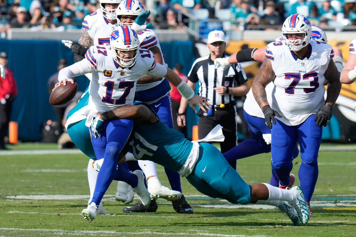 Buffalo Bills quarterback Josh Allen (17) is tackled by Jacksonville Jaguars defensive end Josh ...