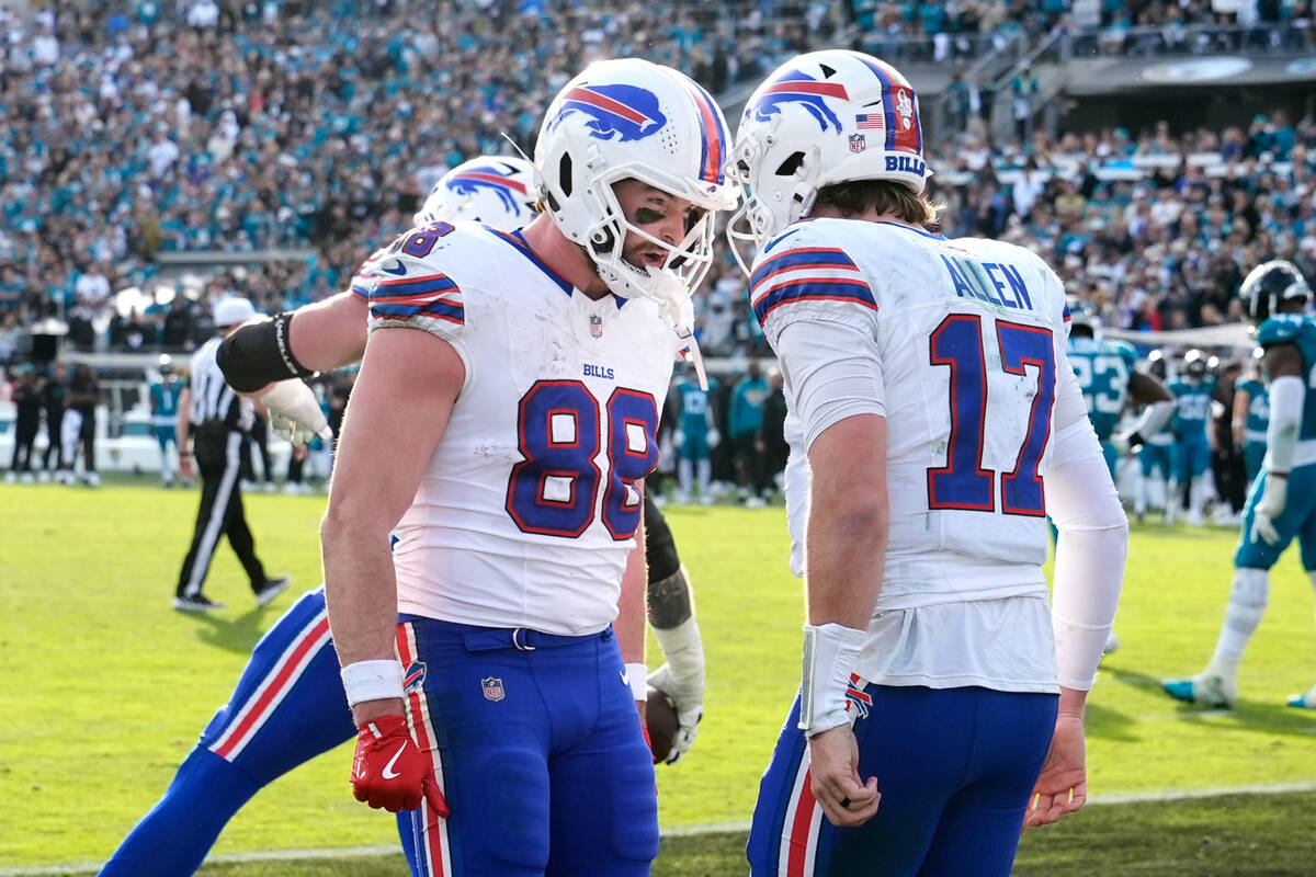 Buffalo Bills quarterback Josh Allen (17) celebrates his touchdown with tight end Dawson Knox ( ...