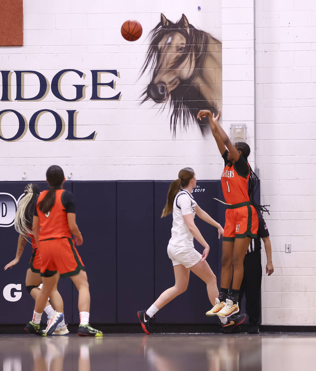 Mojave’s A'yanna Johnson (1) shoots over Shadow Ridge forward Alexa Madsen (5) duri ...