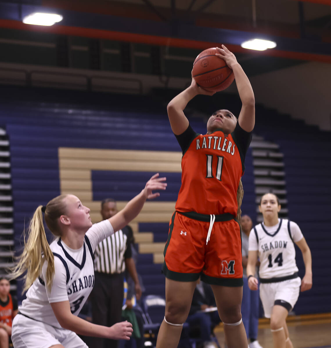 Mojave’s Armonney Wright (11) shoots as Shadow Ridge guard Kambree Graham (3) defends du ...