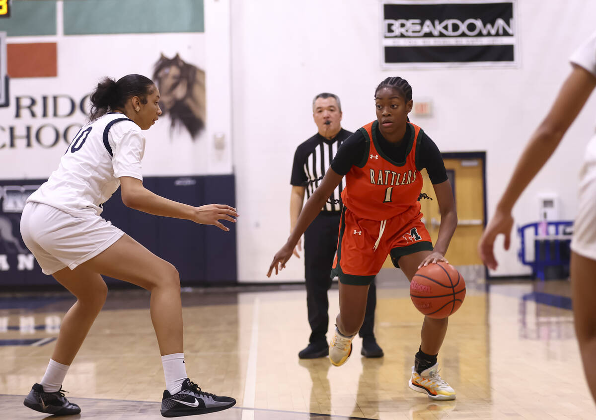 Mojave’s A'yanna Johnson (1) drives the ball against Shadow Ridge forward Jaslyn Je ...