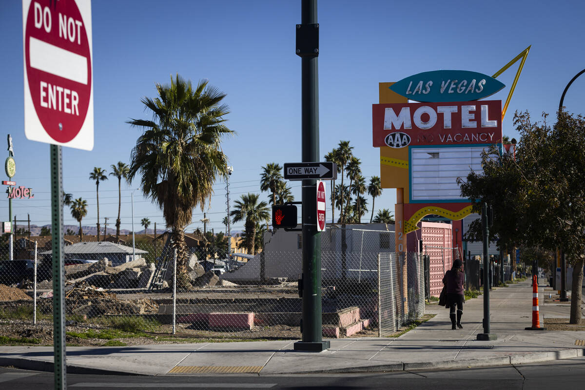 A woman walks by demolished motels along Fremont East, including the Las Vegas Motel, which dat ...