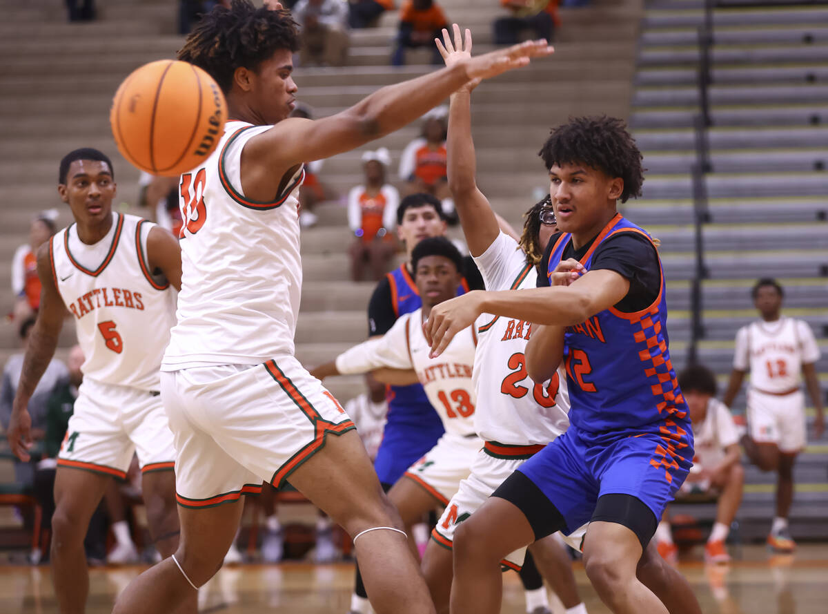 Bishop Gorman forward Braylen Williams (12) passes the ball in front of Mojave forward Ty' ...