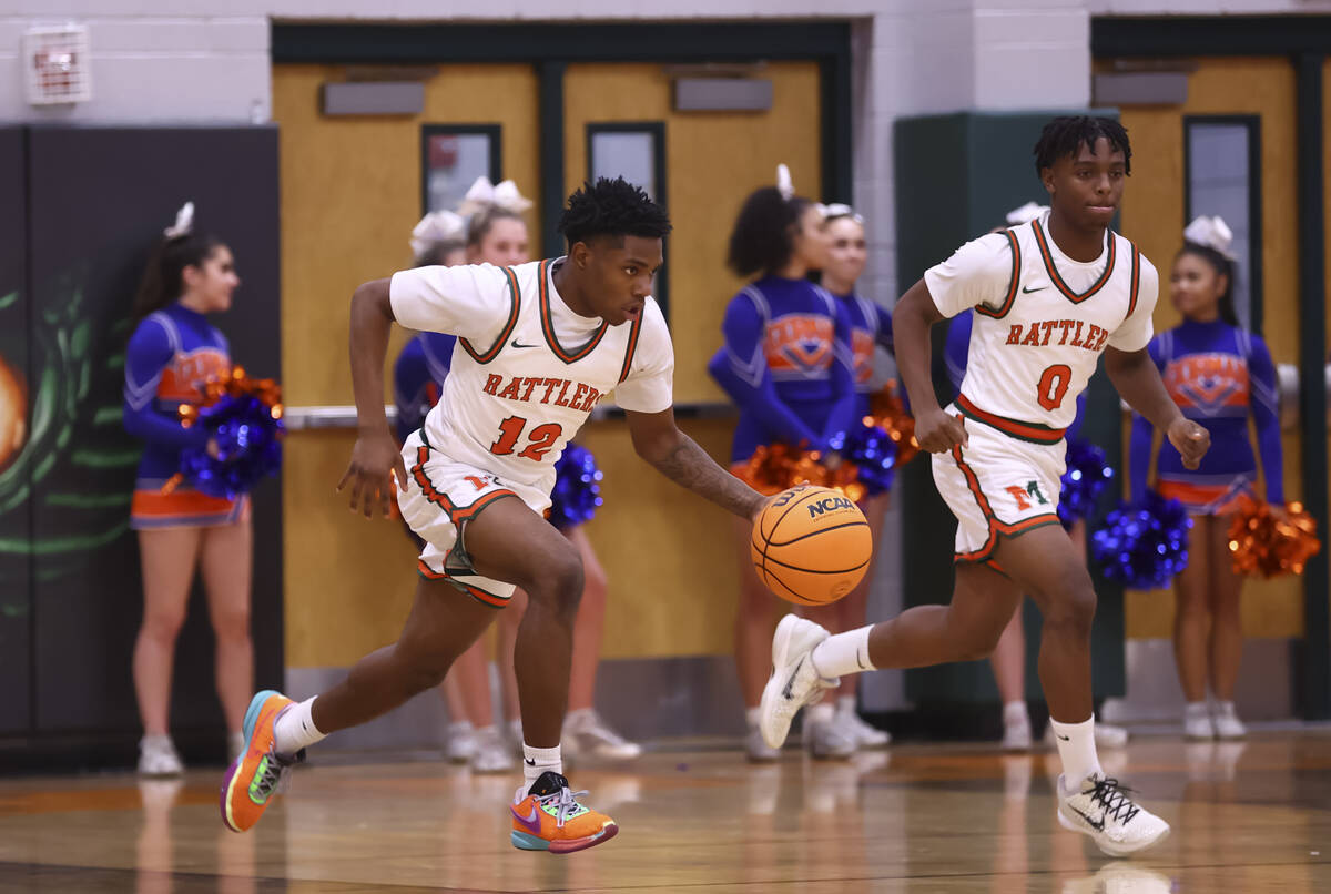 Mojave guard Jabari Washington (12) brings the ball up court against Bishop Gorman during a bas ...