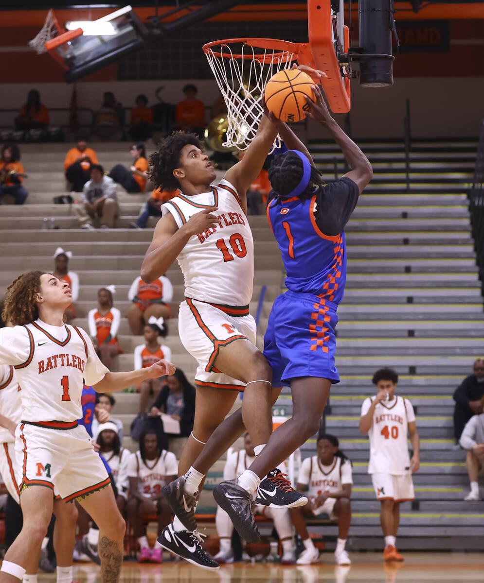 Mojave forward Ty'jir Broxie (10) blocks the lay up of Bishop Gorman guard Ty Johnson (1) ...