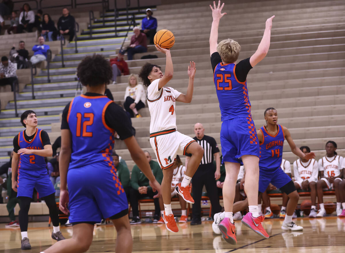 Mojave guard Jayden Luna (4) lays up the ball under pressure from Bishop Gorman center Tyler Br ...