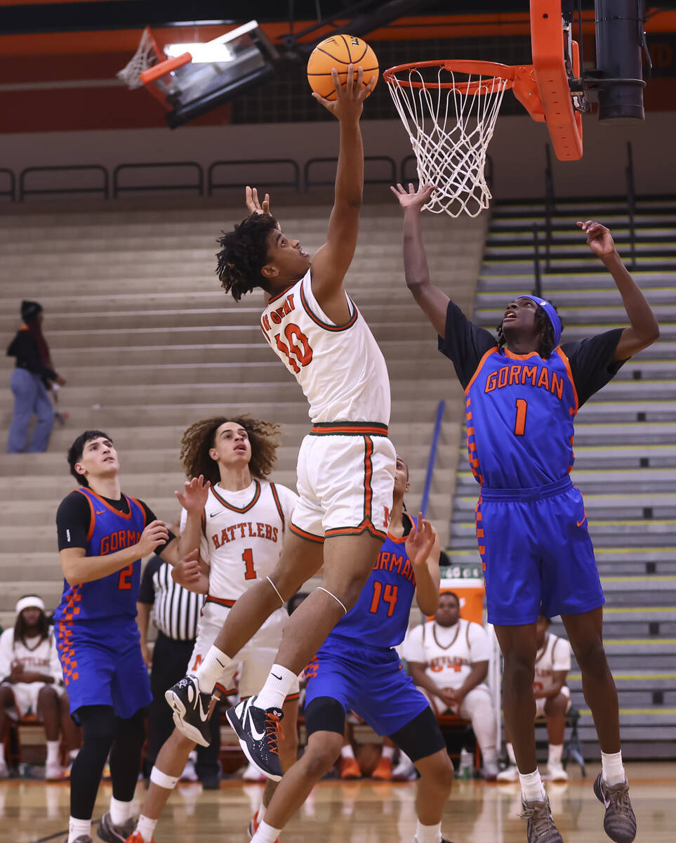 Mojave forward Ty'jir Broxie (10) grabs a rebound against Bishop Gorman guard Ty Johnson ( ...