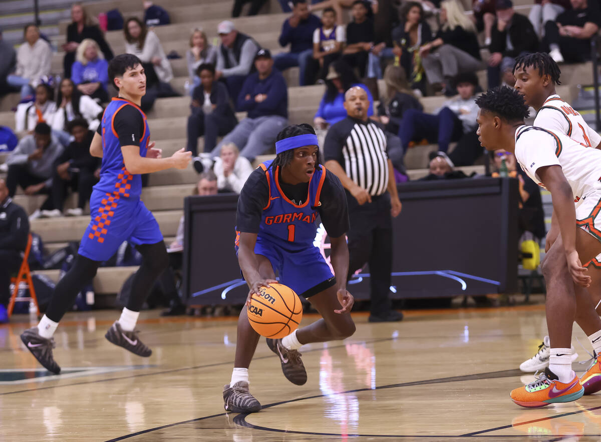 Bishop Gorman guard Ty Johnson (1) brings the ball up court during a basketball game at Mojave ...