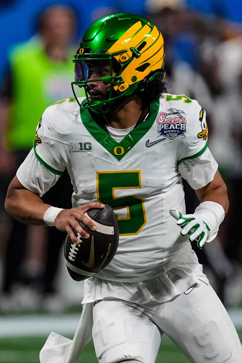 Oregon quarterback Dante Moore (5) works in the pocket against the Indiana during the second ha ...