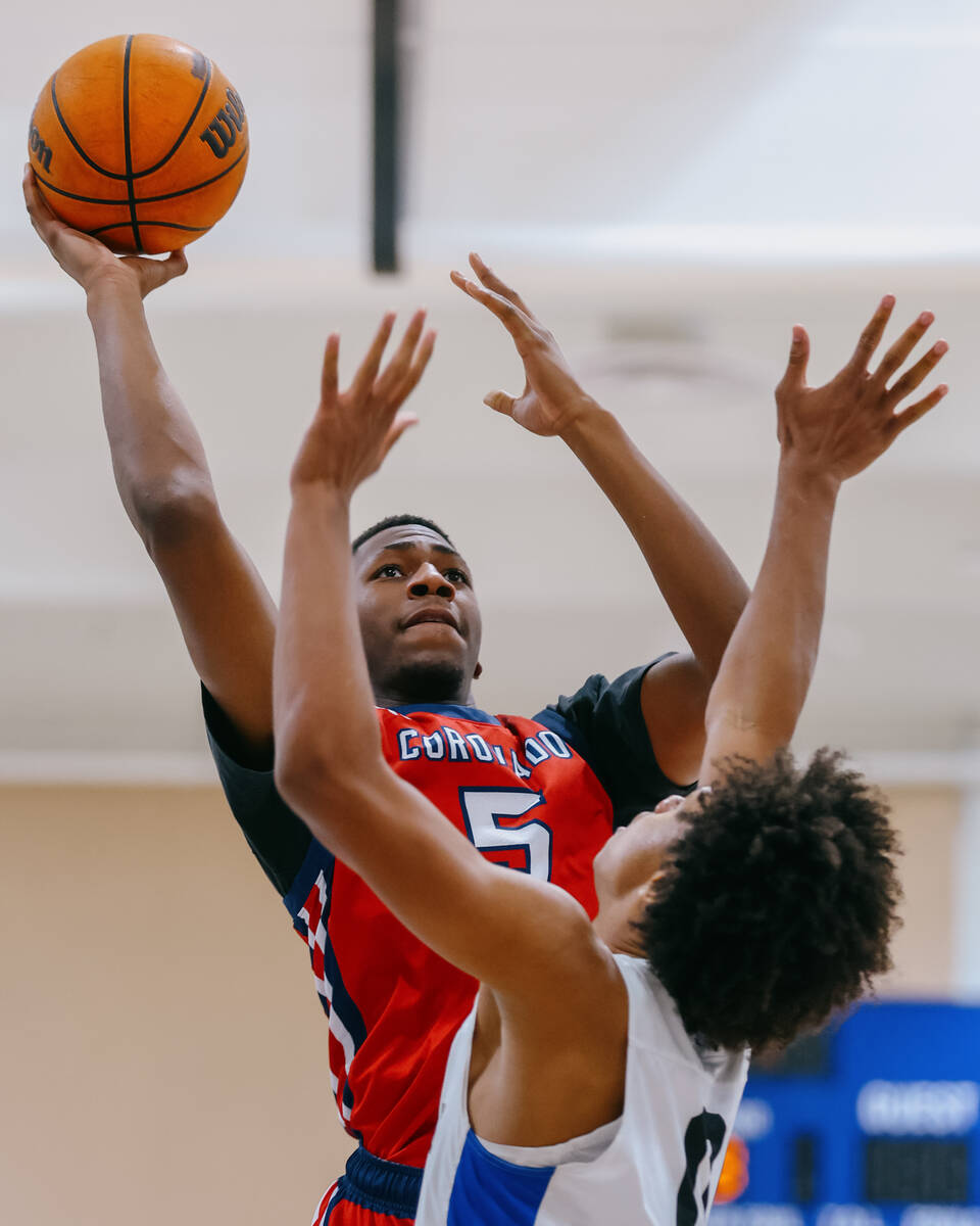 Coronado wing DeVaughn Dorrough (5) takes a shot over Democracy Prep guard/forward Ien Kirkland ...