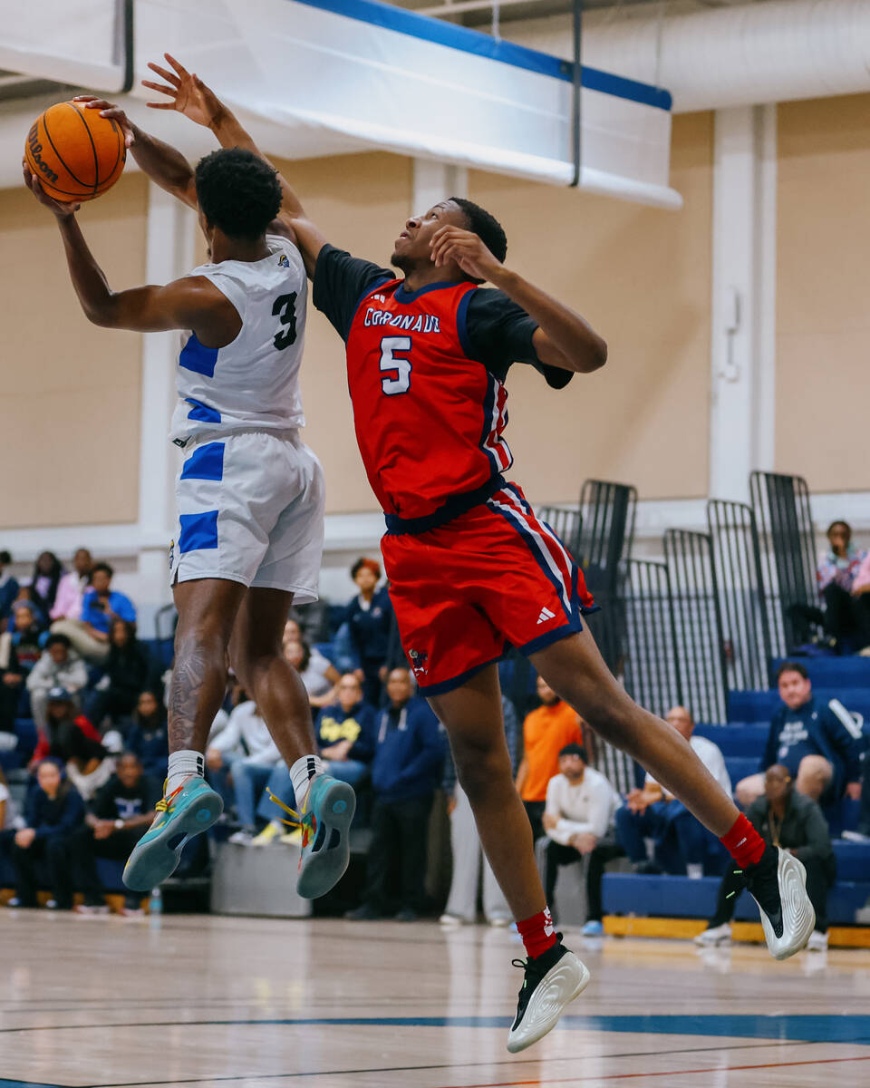 Coronado wing DeVaughn Dorrough (5) leaps up to prevent Democracy Prep guard Dashuan Harris (3) ...