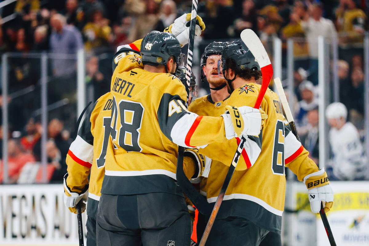 Golden Knights players celebrate a goal during an NHL hockey game between the Golden Knights an ...