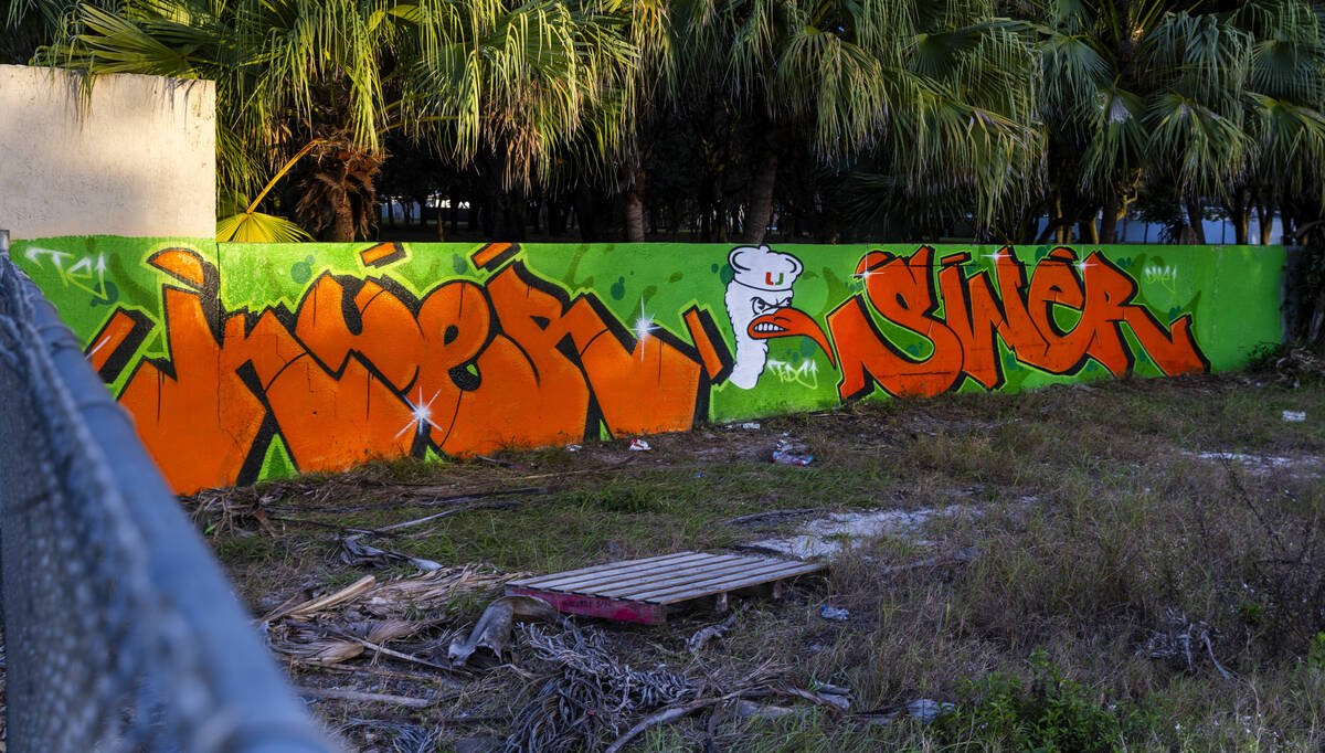 A wall with graffiti and a University of Miami logo is seen across from the Hard Rock Stadium F ...