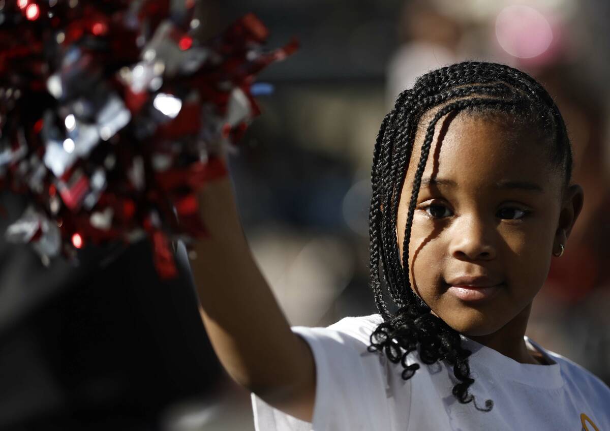 Brielle Whitley, 4, waves to the crowd during the Dr. Martin Luther King Jr. parade Monday Jan. ...
