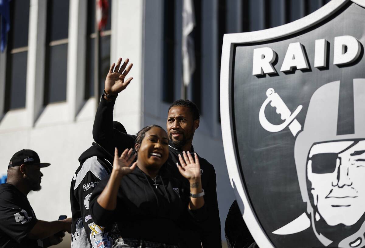 Members of the Raiders organization wave to the crowd during the Dr. Martin Luther King Jr. par ...