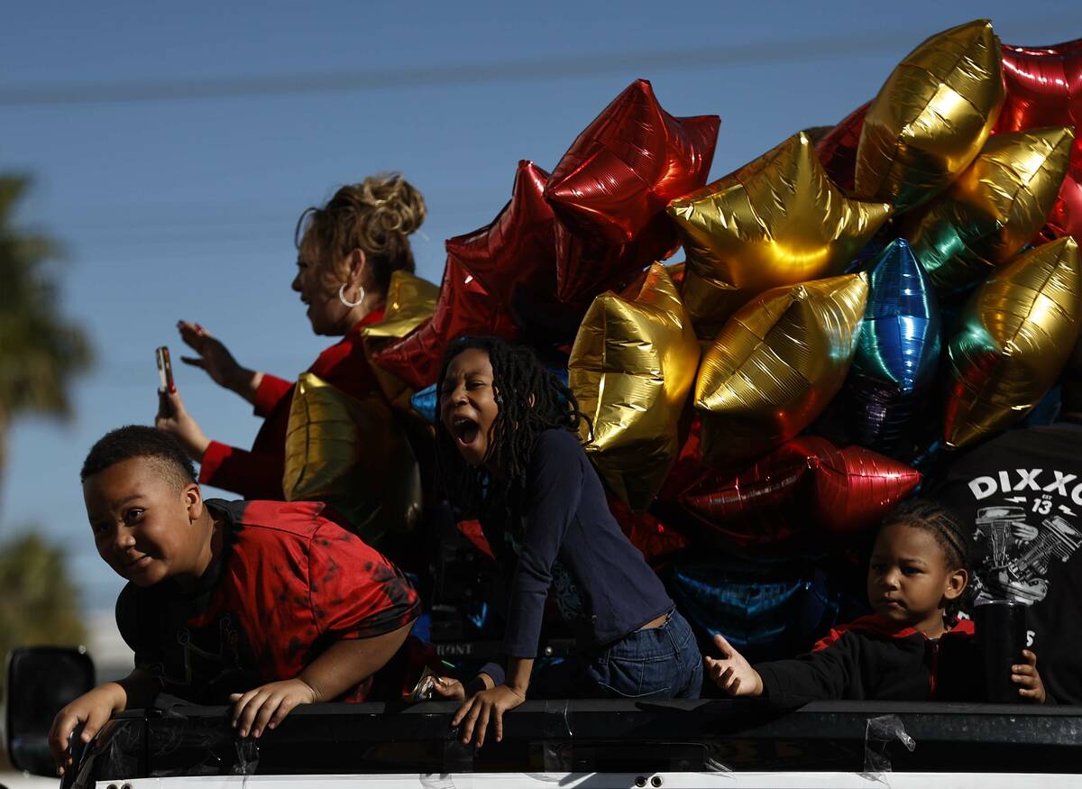 Kids on Judge Mari Parladé’s election truck gesture towards the crowd during the Dr. Martin ...