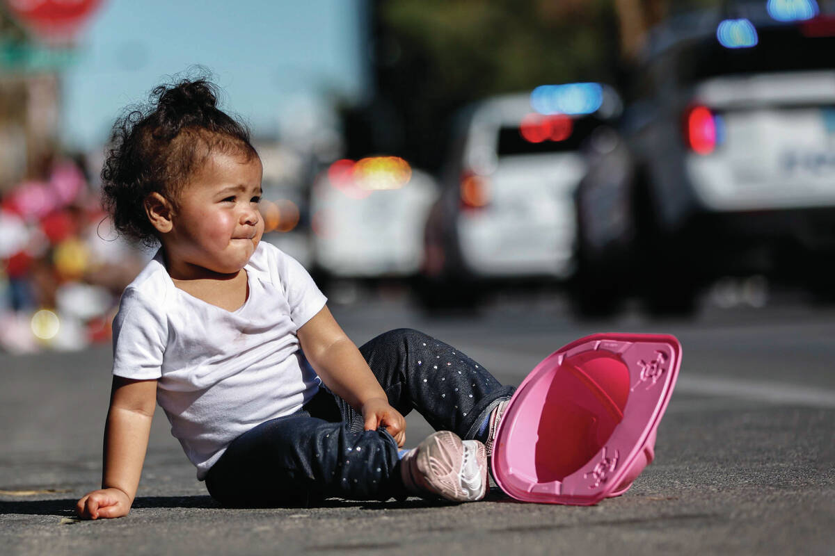Kahlani Christina, 1, watches the Dr. Martin Luther King Jr. parade as it passes down 4th Stree ...