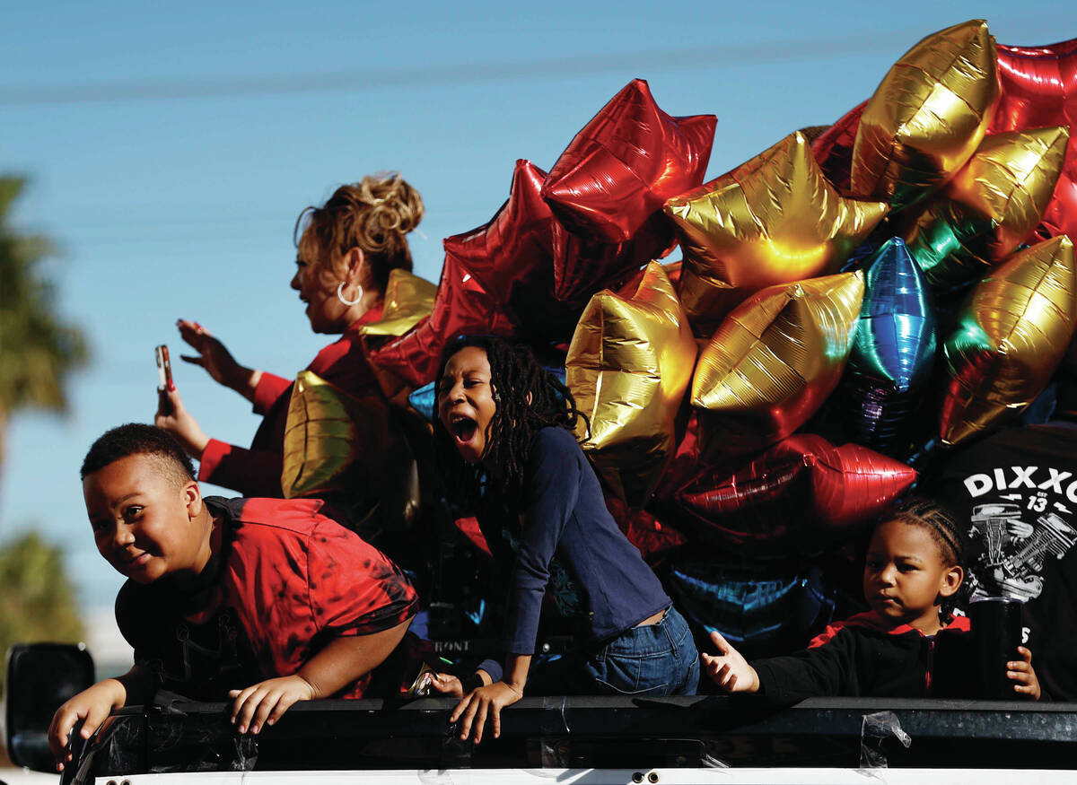 Kids on Judge Mari Parladé’s election truck gesture towards the crowd during the Dr ...