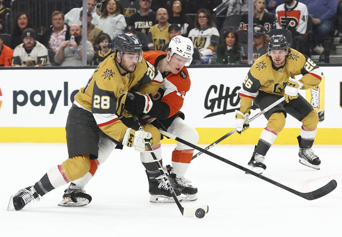 Golden Knights center Tanner Laczynski (28) skates with the puck under pressure from Philadelph ...