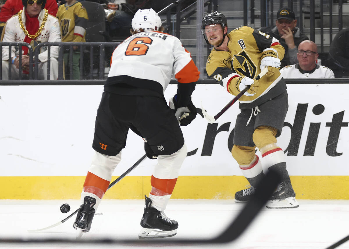 Golden Knights center Jack Eichel (9) passes the puck under pressure from Philadelphia Flyers d ...