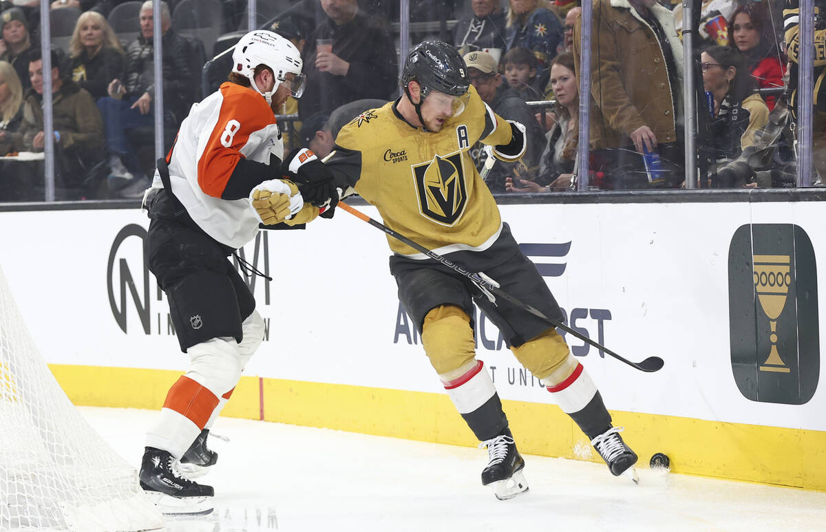 Golden Knights center Jack Eichel (9) tries to keep the puck from Philadelphia Flyers defensema ...