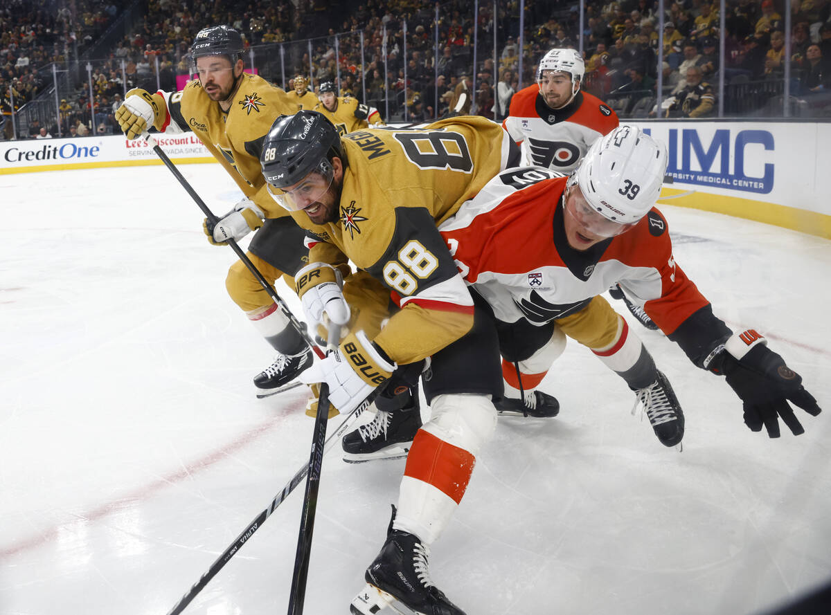 Golden Knights defenseman Jaycob Megna battles for the puck against Philadelphia Flyers right w ...
