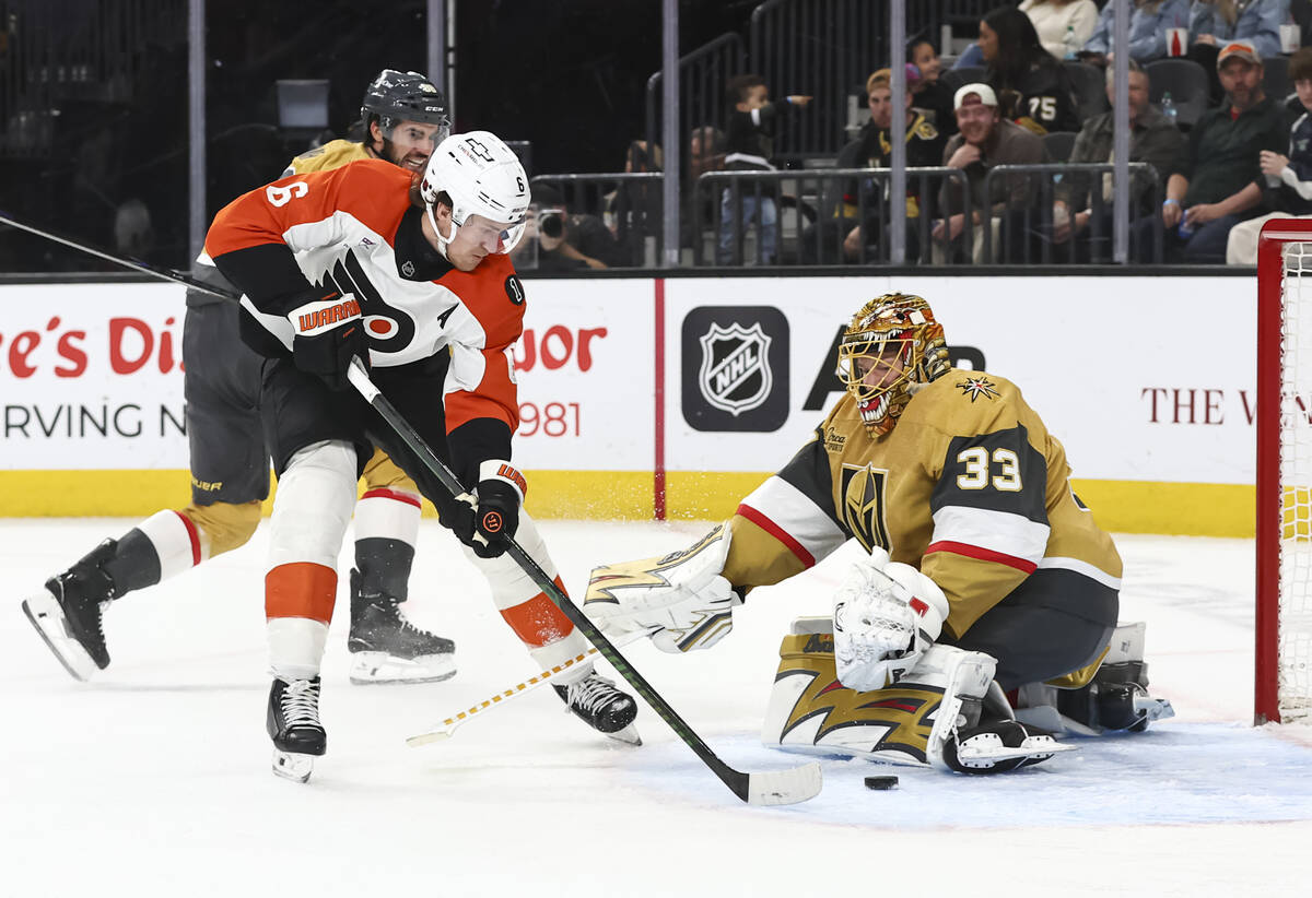 Golden Knights goaltender Adin Hill (33) defends the net as Philadelphia Flyers defenseman Trav ...
