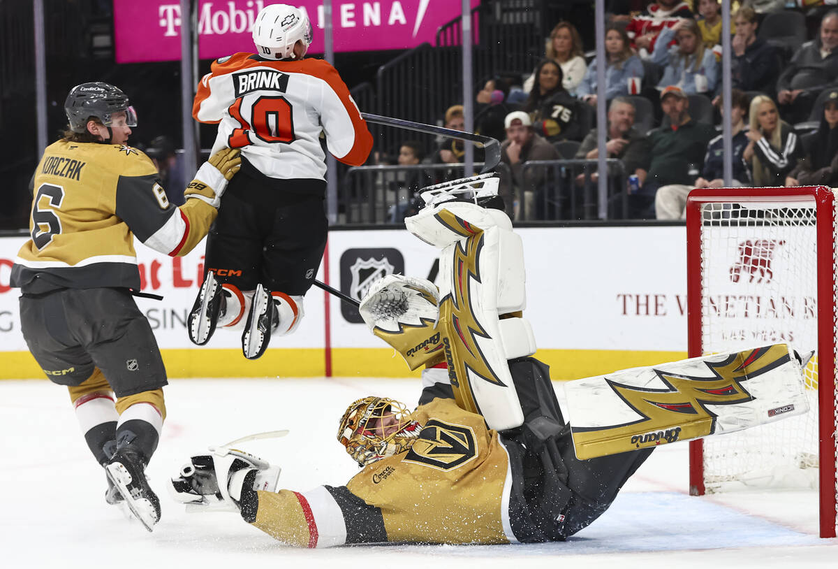 Golden Knights goaltender Adin Hill (33) slips to the ice after blocking the puck, out of frame ...