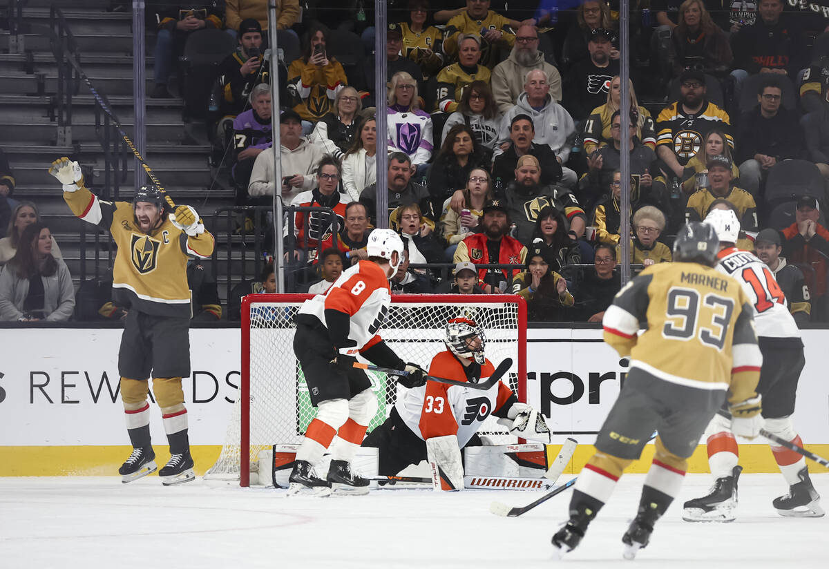 Golden Knights right wing Mark Stone, left, celebrates the goal of Golden Knights center Tomas ...