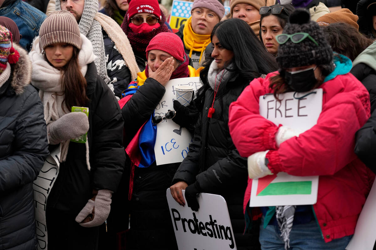 Protesters gather at the shooting site where Renee Good was fatally shot by an ICE officer earl ...