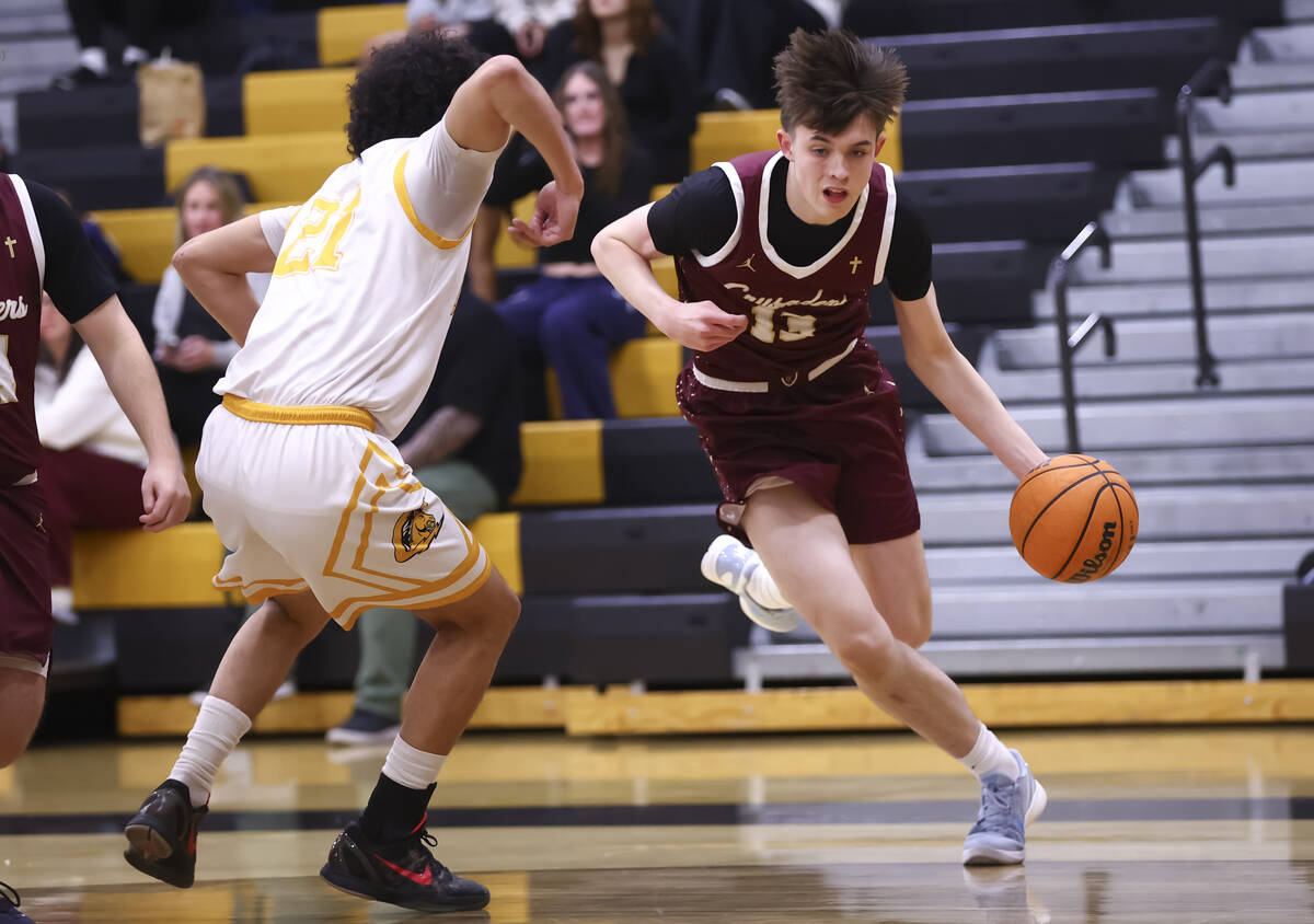 Faith Lutheran's Dashel Wiley (13) drives to the basket against Clark’s Drake Afe-Passion (21 ...