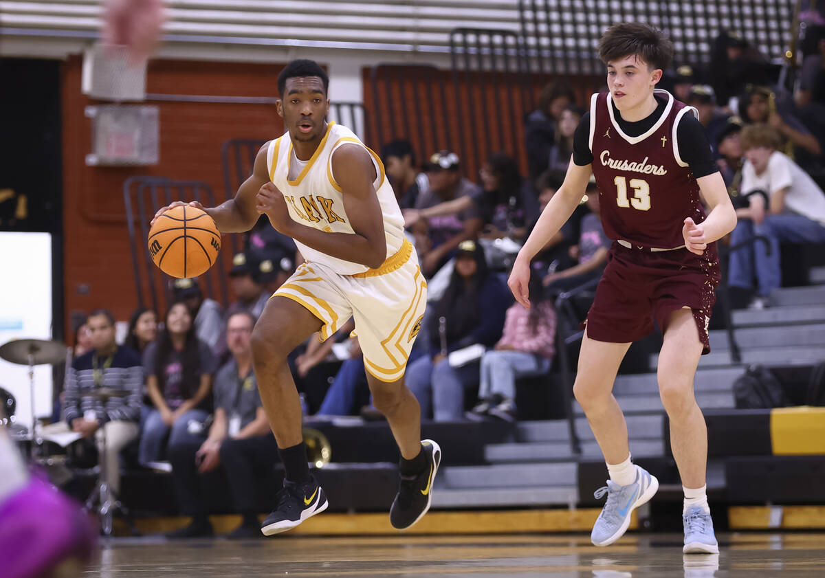 Clark’s Devan Christion (35) brings the ball up court against Faith Lutheran's Dash ...