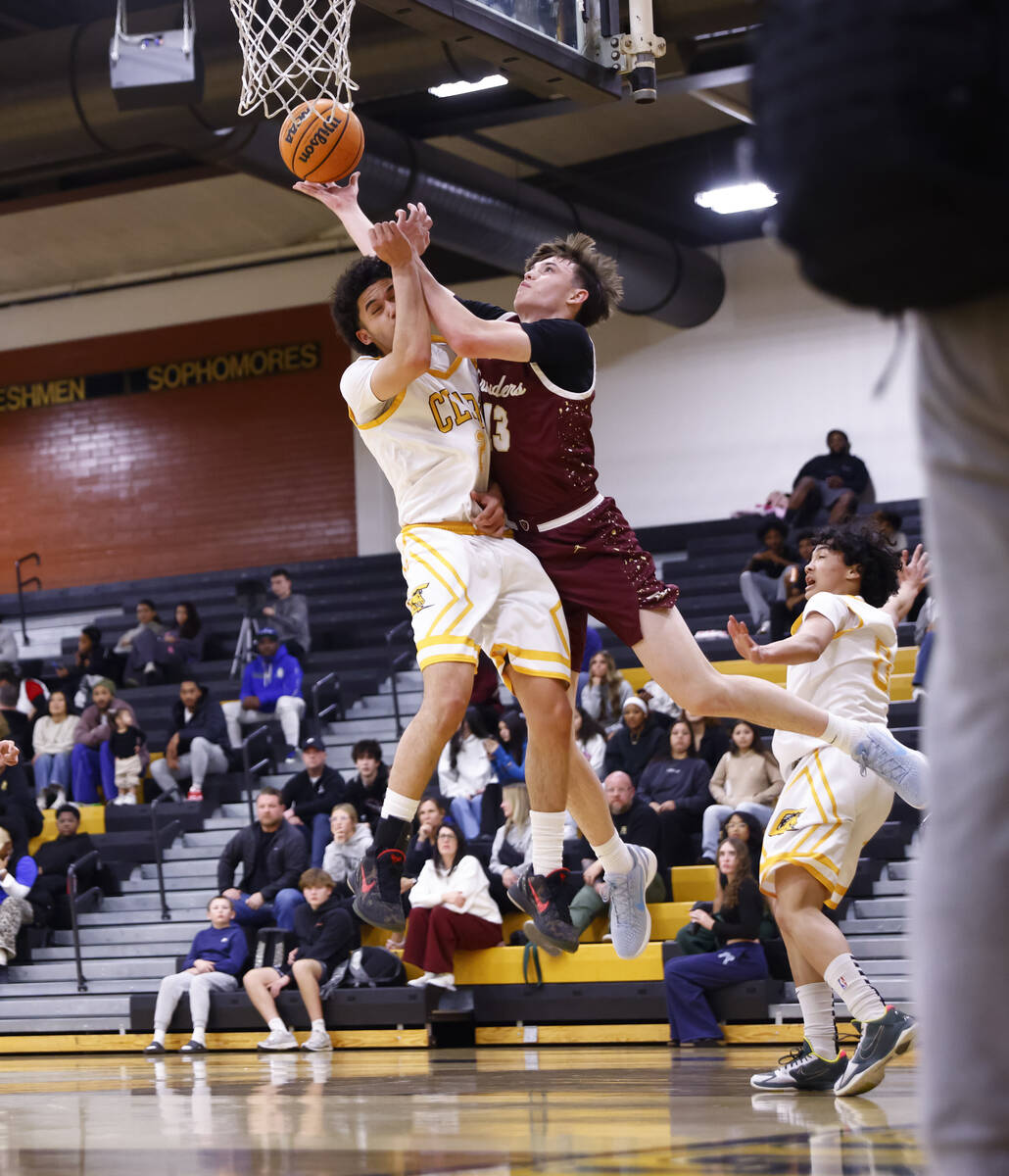 Faith Lutheran's Dashel Wiley (13) lays up the ball against Clark’s Drake Afe-Passion (21) du ...