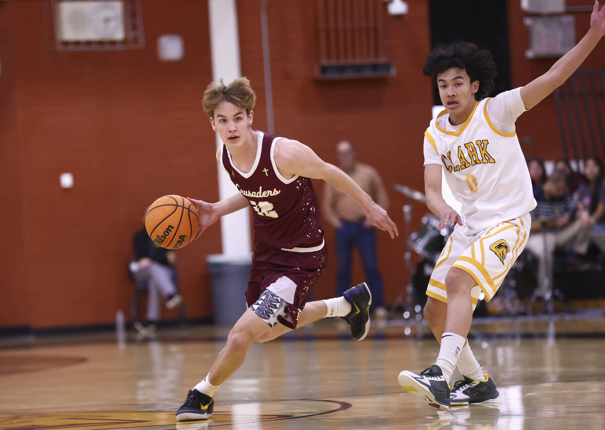 Faith Lutheran's Bentley Swinn (12) drives the ball past Clark's CJ Edwards (0) durin ...