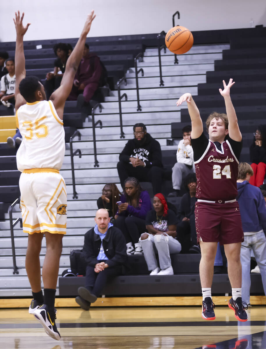 Faith Lutheran's Mason Schweitzer (24) shoots against Clark’s Devan Christion (35) ...