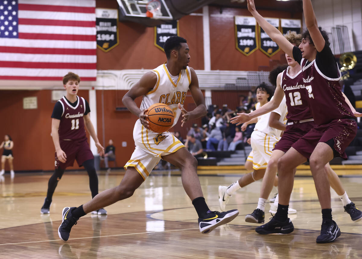 Clark’s Devan Christion (35) drives to the basket against Faith Lutheran during a basket ...