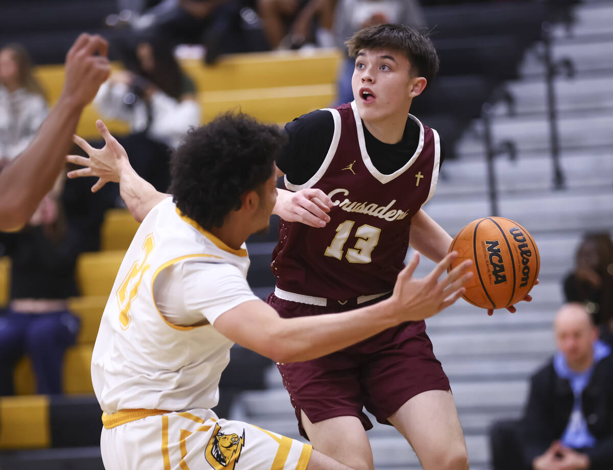 Faith Lutheran's Dashel Wiley (13) looks to pass the ball under pressure from Clark’s Drake A ...