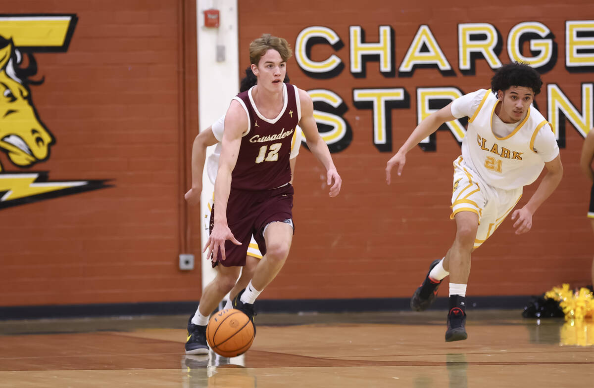 Faith Lutheran's Bentley Swinn (12) brings the ball up court during a basketball game at C ...