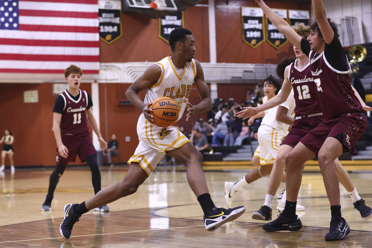 Clark’s Devan Christion (35) drives to the basket against Faith Lutheran during a basket ...