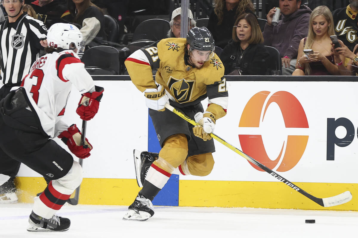 Golden Knights center Brett Howden (21) skates with the puck under pressure from New Jersey Dev ...
