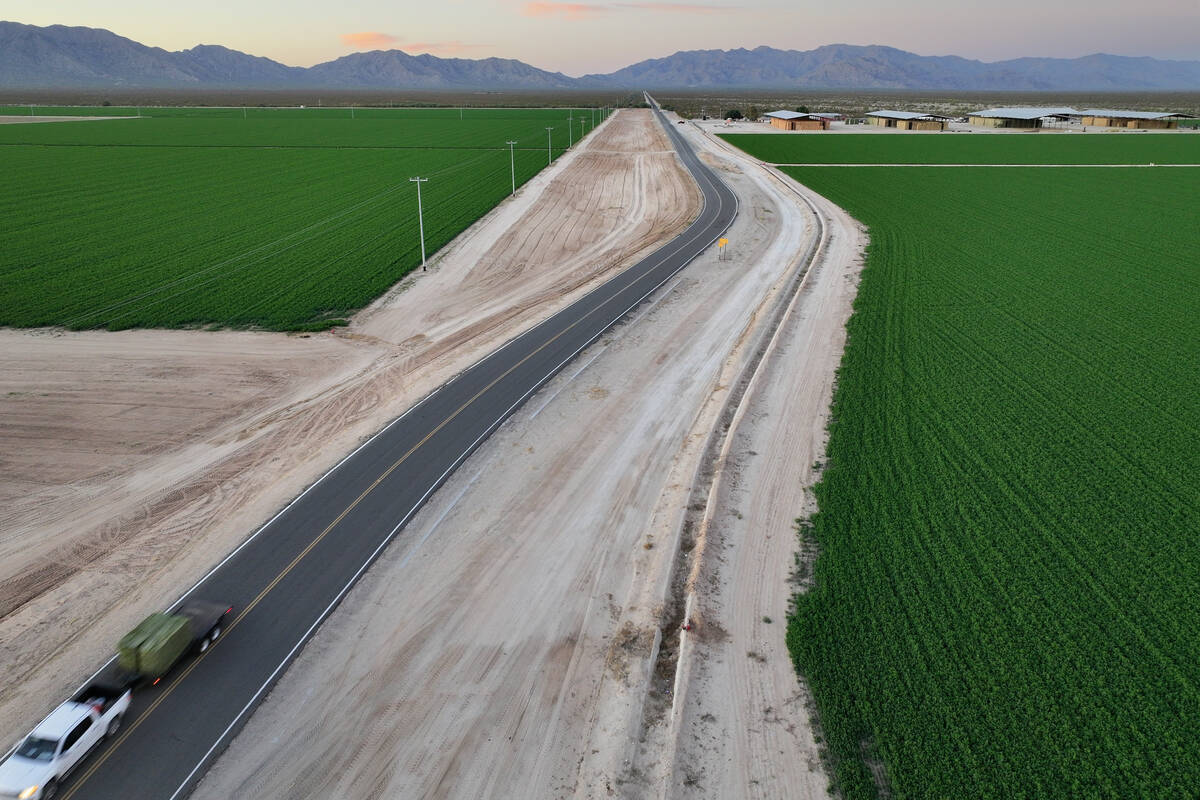 A truck hauling hay drives near Al Dahra Farms on Oct. 17, 2023, in the McMullen Valley in Wend ...