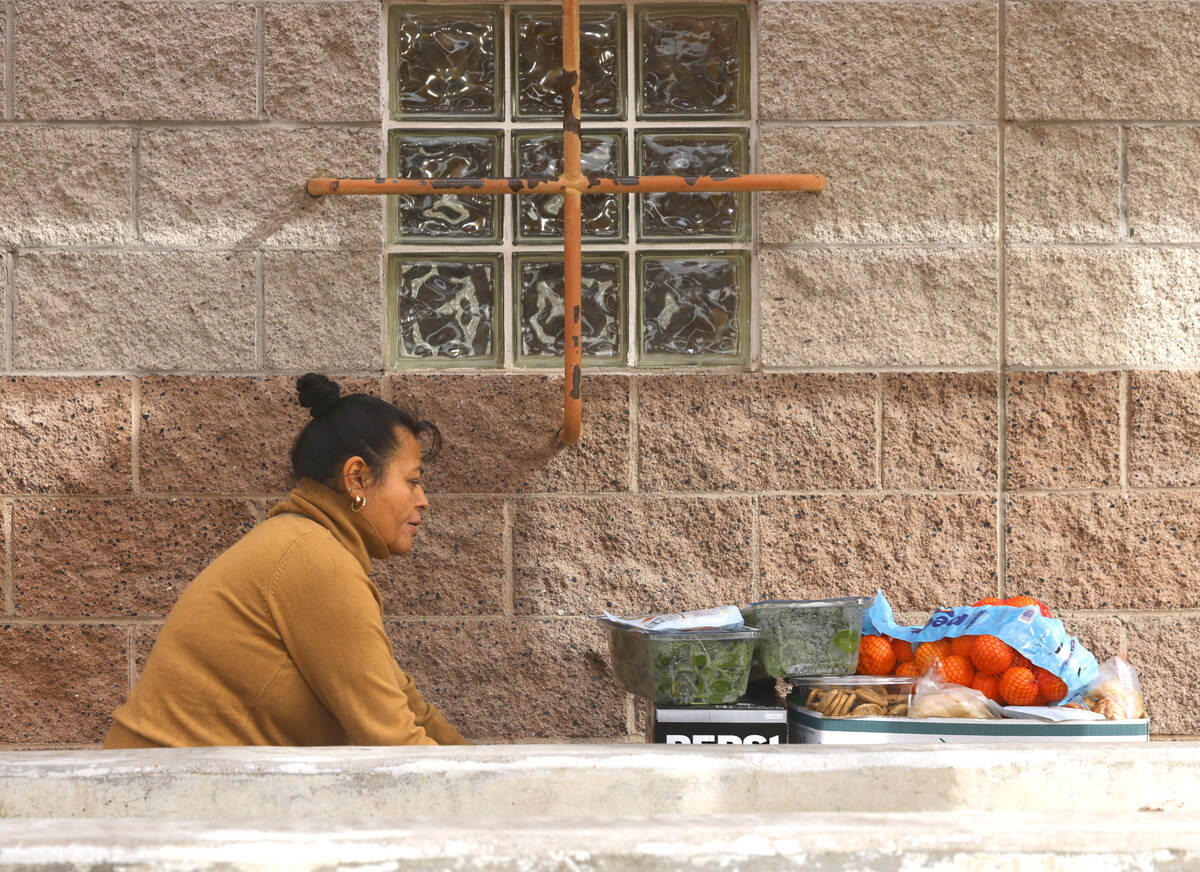 Maria Catiyo picks up food pantry items at Catholic Charities of Southern Nevada on Wednesday, ...