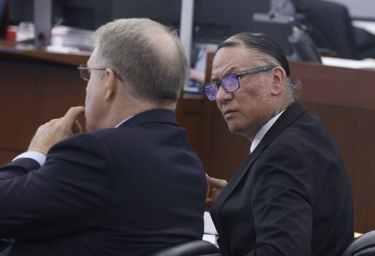 Nathan Chasing Horse, right, looks at his attorney Craig Mueller during his trial on charges of ...