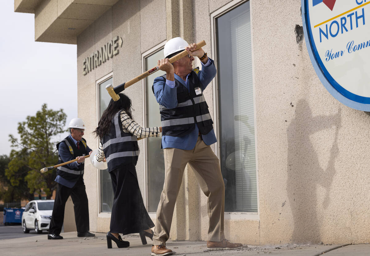 North Las Vegas City Councilman Scott Black, right, swings a sledgehammer during an event to ki ...