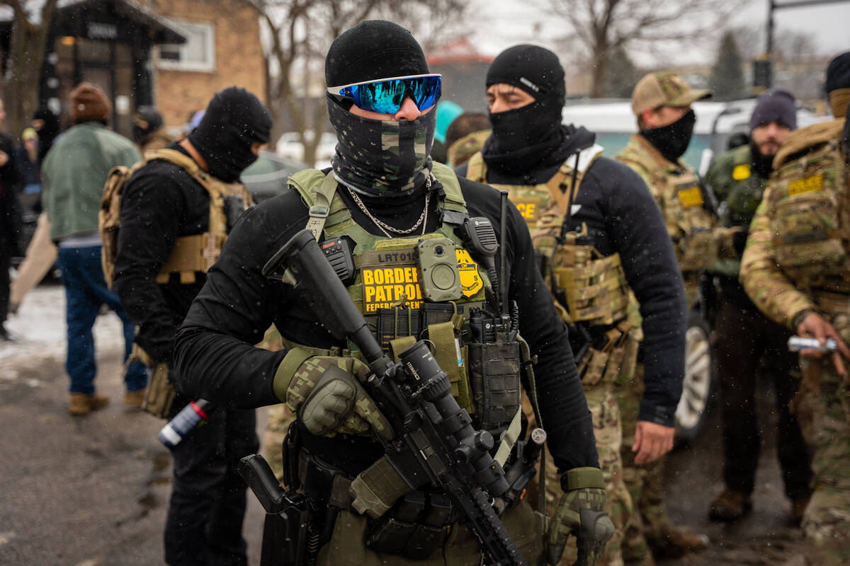Federal agents on Wednesday, Jan. 21, 2026, in Minneapolis. (AP Photo/Angelina Katsanis)