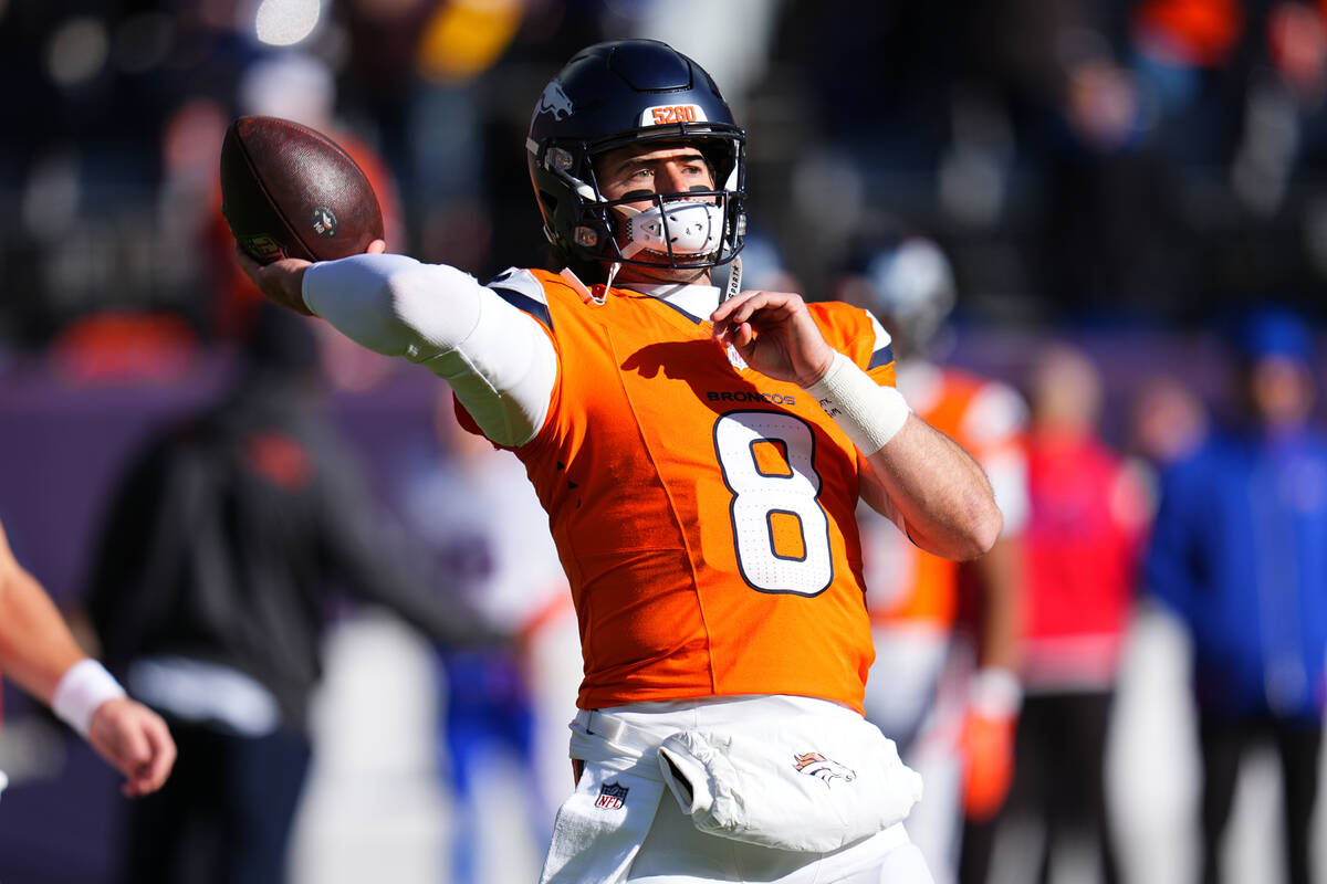 Denver Broncos quarterback Jarrett Stidham warms up before an NFL divisional round playoff foot ...