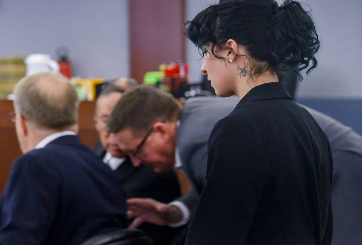 Nathan Chasing Horse, center, talks to Patrick Hardy, a private investigator, as Corena Leone-L ...