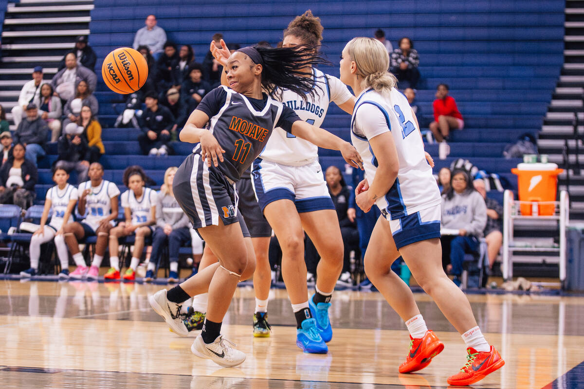 Mojave guard Armonney Wright (11) eyes the ball as it escapes her during a girls basketball gam ...