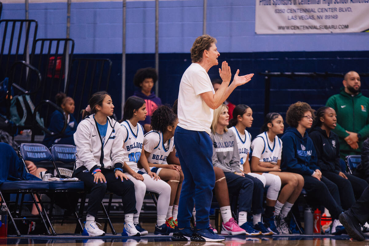 Centennial head coach Karen Weitz claps as she coaches during a girls basketball game against M ...
