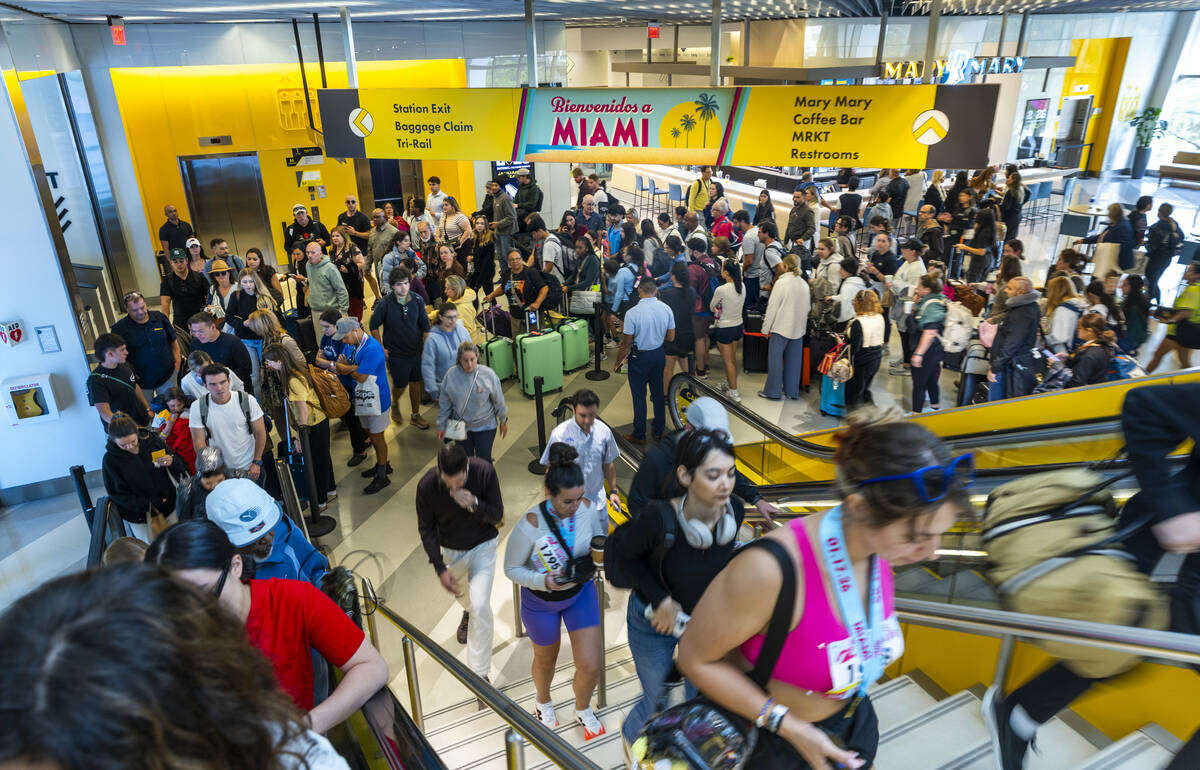 Passengers head to their incoming train at the Brightline MiamiCentral Station on Saturday, Jan ...